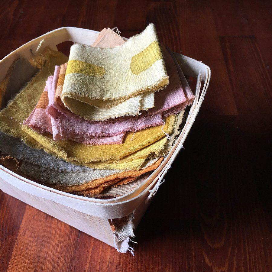 A basket of natural dye swatches
