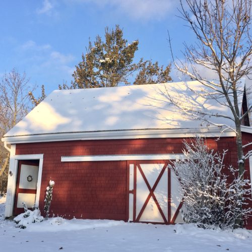 Red barn covered in snow